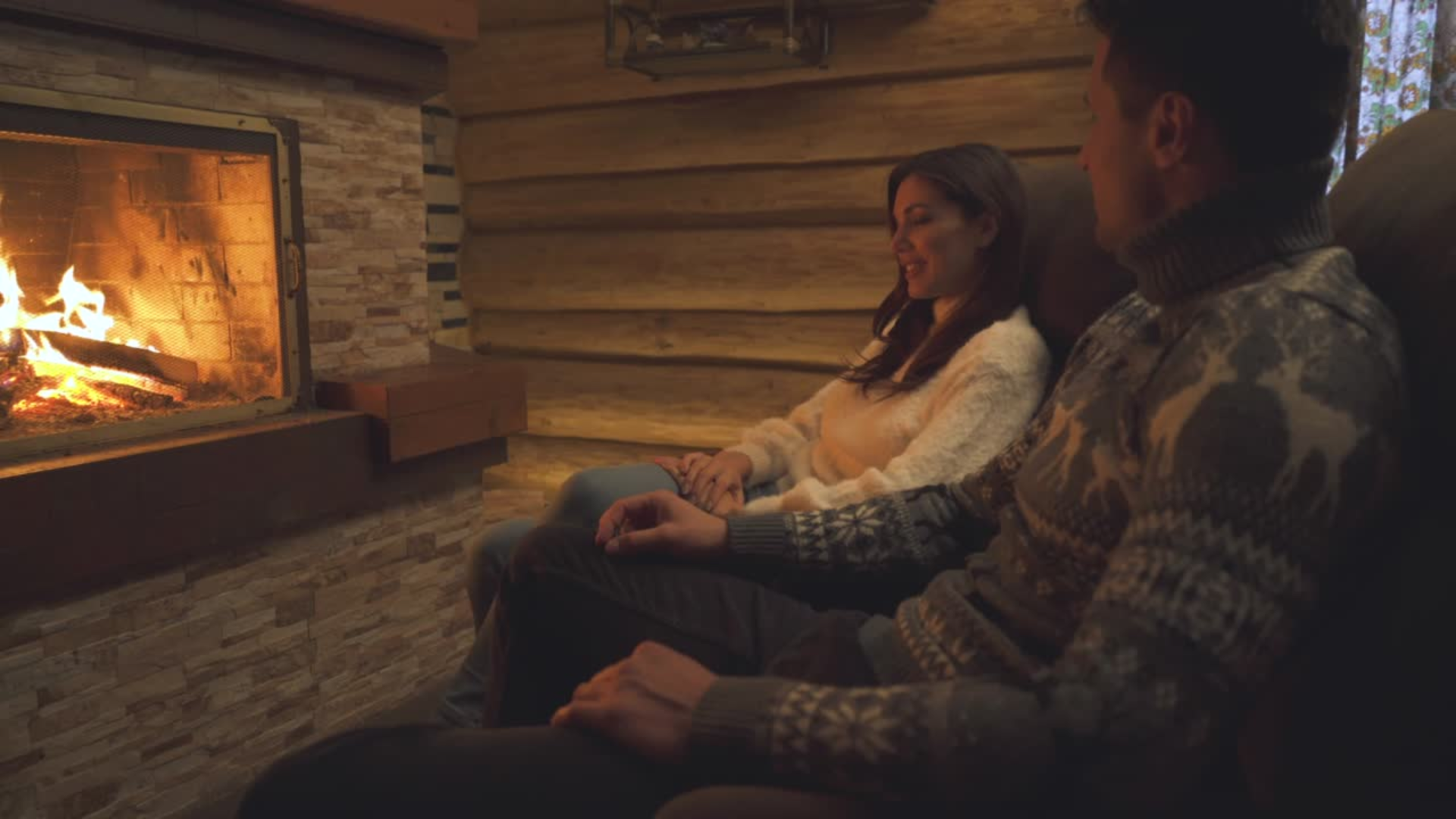 The young couple relaxing near the fireplace